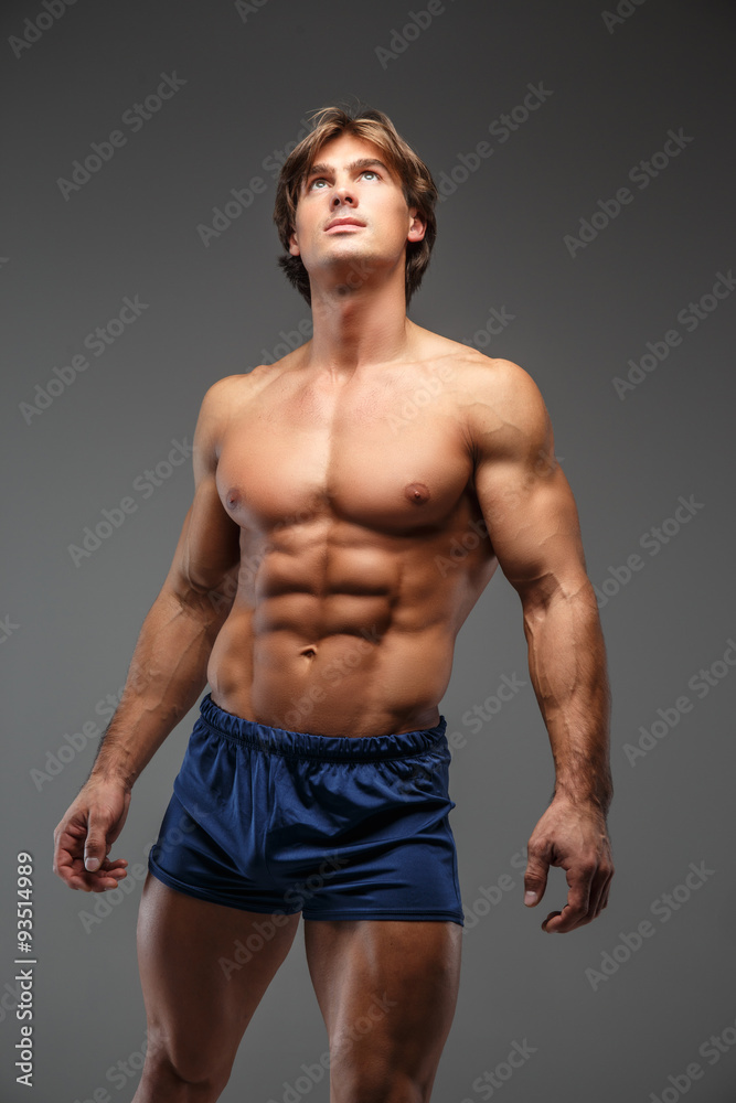 Attractive muscular man in blue shorts.