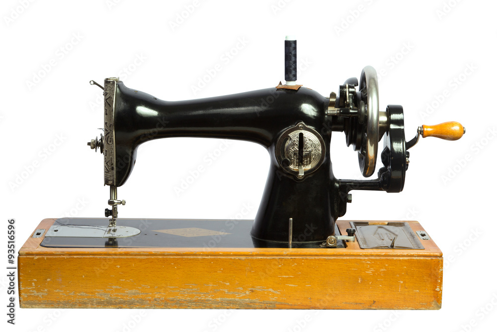 Old black sewing machine isolated ob white