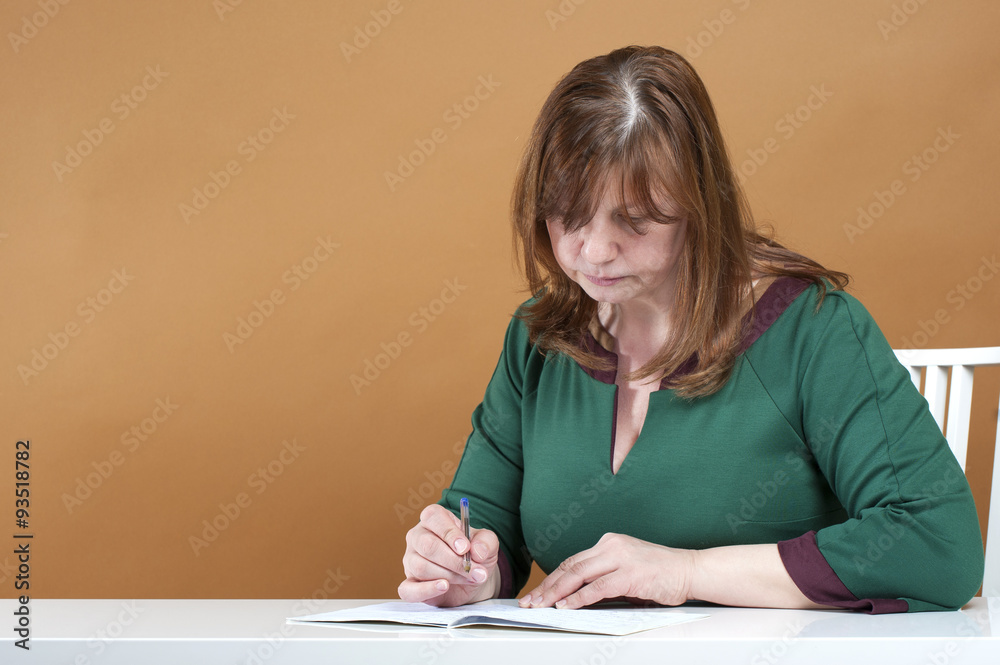 Middle-aged woman checks the notebook.. Middle-aged woman checks the notebook..