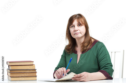 Middle-aged woman teacher checks the notebook..