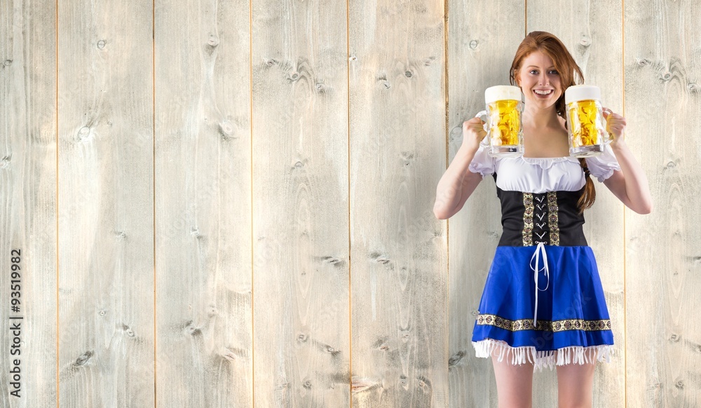Obraz premium Composite image of oktoberfest girl holding jugs of beer