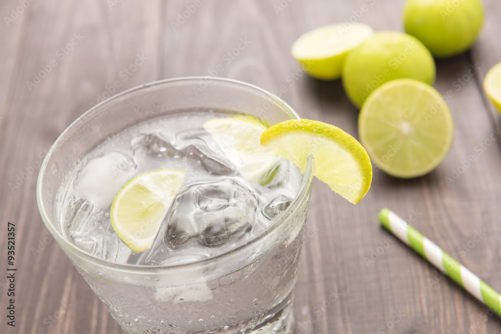 Fresh cocktail with soda, lime on a wooden background Fresh cocktail with soda, lime on a wooden background