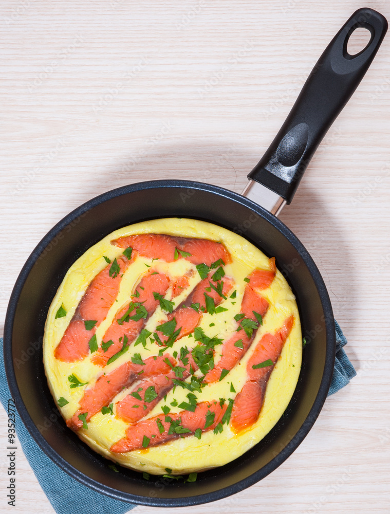 omelet with smoked salmon in a frying pan omelet with smoked salmon in a frying pan
