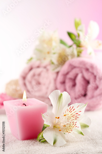 Spa treatment and flowers on wooden table  on light background