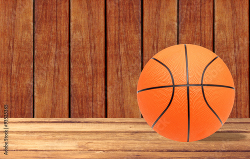 Basketball ball on the wooden table over wooden background © wolfelarry