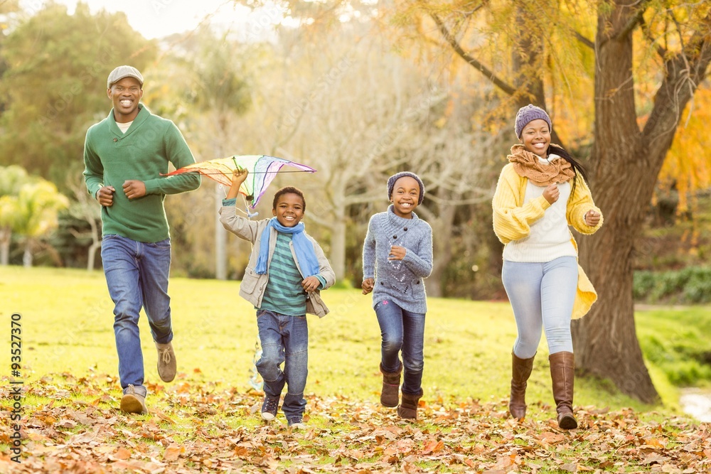 Young family playing with a kite