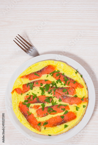 omelet with smoked salmon in a frying pan