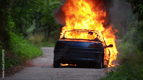 Burning Car, fire fighters extinguish the fire.