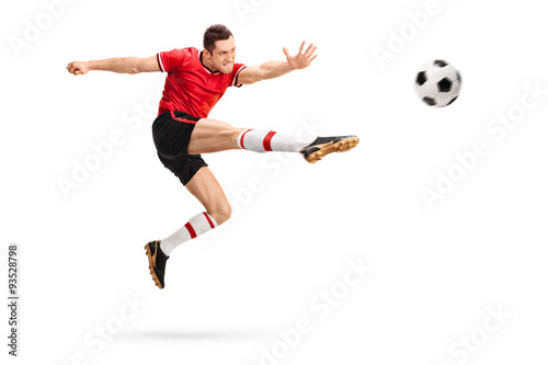 Football player kicking a ball in mid-air © Ljupco Smokovski