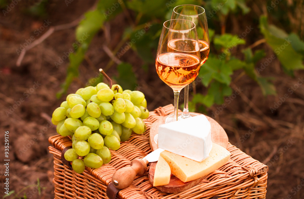 Various sorts of cheese, Two glasses of white wine in the garden
