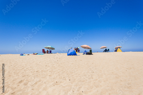 Beach Holidays umbrellas people sands blue ocean sky 