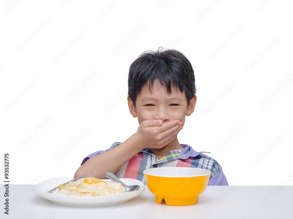 Asian child close his mouth by hand between having lunch Asian child close his mouth by hand between having lunch