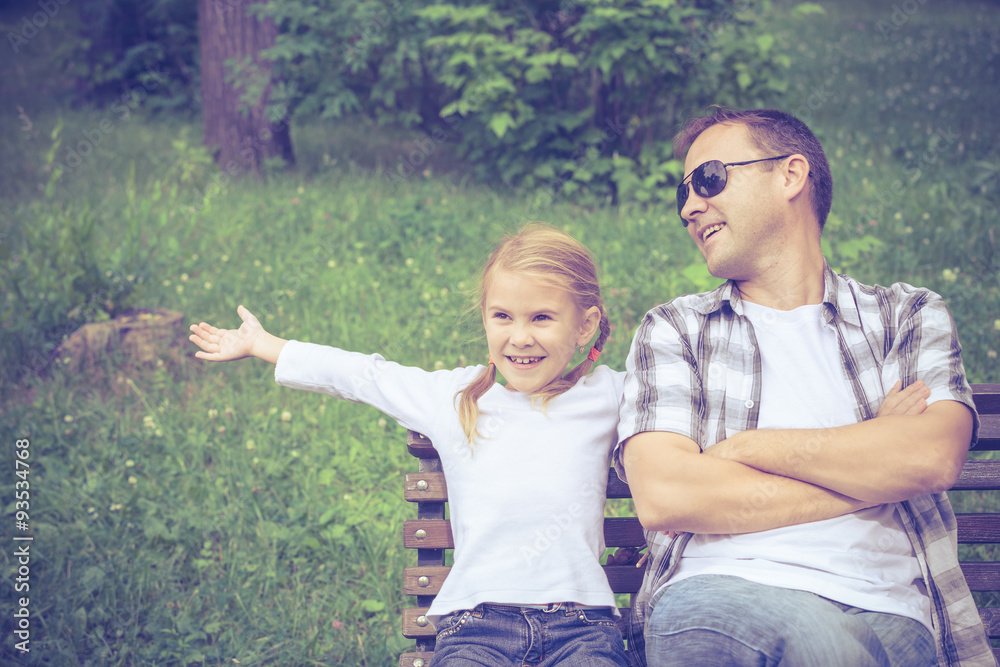 Father and daughter playing at the park at the day time. Father and daughter playing at the park at the day time.