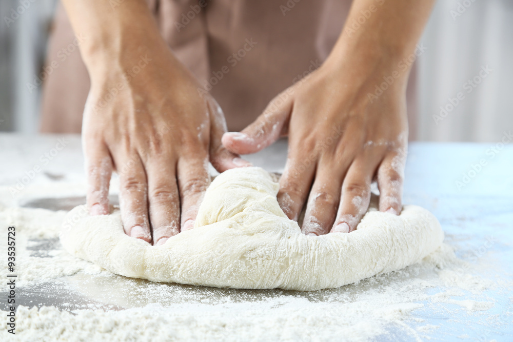 Making dough by female hands at bakery Making dough by female hands at bakery