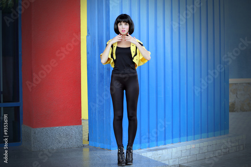 Fotografie Young woman on the wall background
