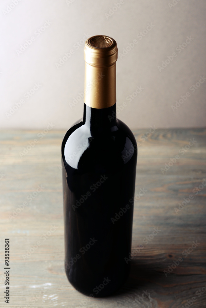 Fototapeta premium Bottle of red wine on wooden table