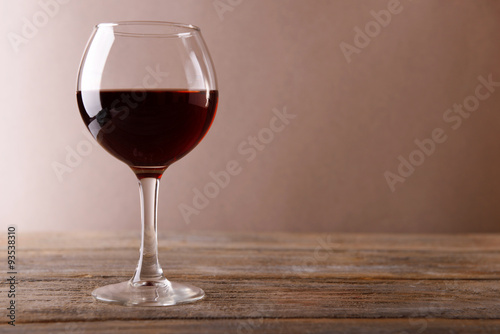 Glass of red wine on wooden table