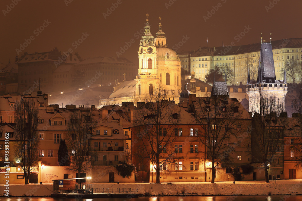 Night romantic snowy Prague St. Nicholas' Cathedral, Czech republic