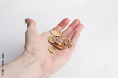 Coins in palm on white background