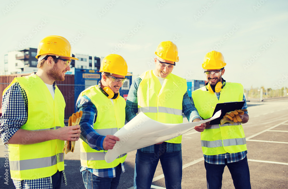group of builders with tablet pc and blueprint group of builders with tablet pc and blueprint