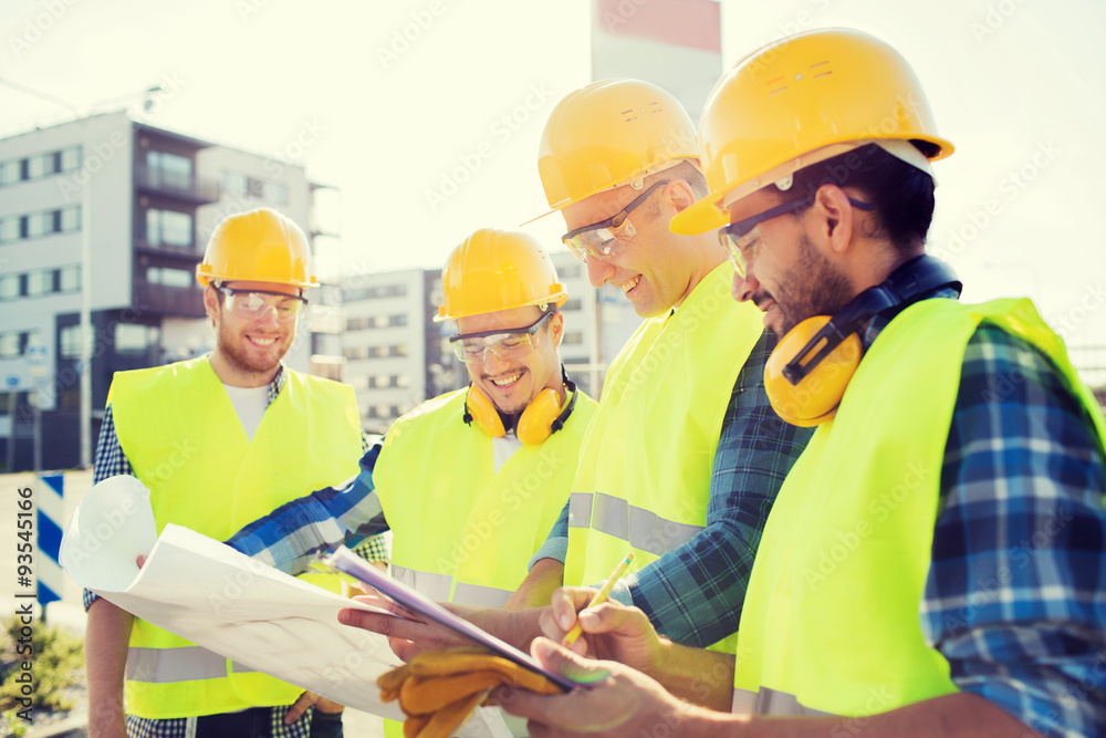 group of builders with tablet pc and blueprint group of builders with tablet pc and blueprint