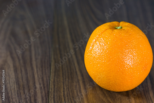 Orange fruit on wooden background.