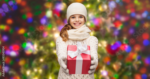 girl in hat, muffler and gloves with gift box