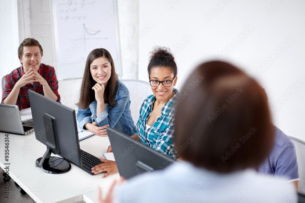 happy students and teacher in computer class