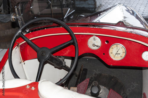 Old red car. Interior with steering wheel. © Marcin Chodorowski