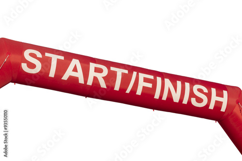 A Red start and finish line inflatable banner isolated against white a background. Banner was marking the start of a 5K run but could be used for any purpose. 