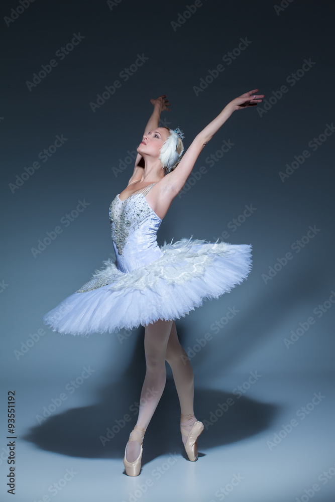 Obraz premium Portrait of the ballerina in ballet tatu on blue background