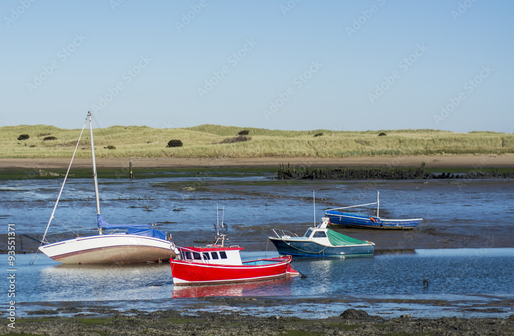Obraz premium Fishing boats at shore during low tide
