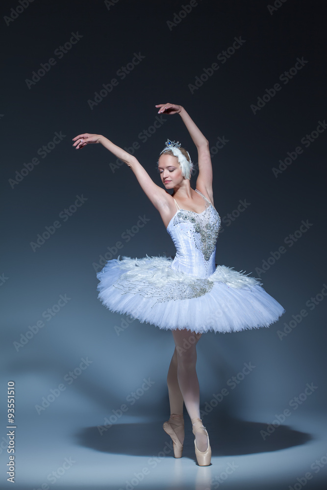 Fototapeta premium Portrait of the ballerina in ballet tatu on blue background