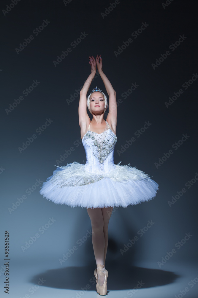 Naklejka premium Portrait of the ballerina in ballet tatu on blue background
