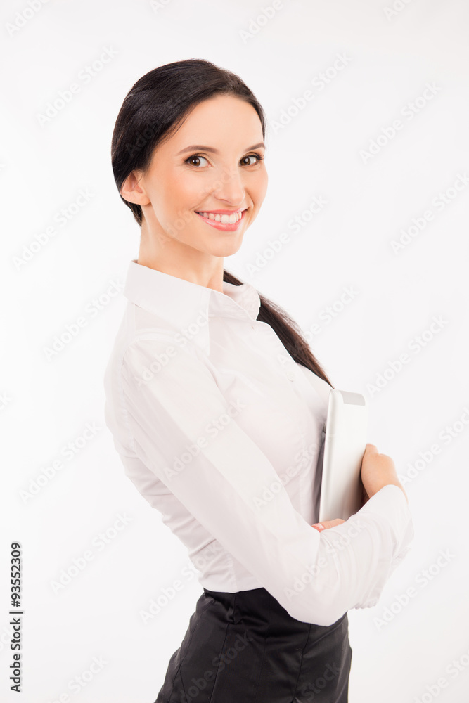 elegant smart businesswoman holding tablet and smiling elegant smart businesswoman holding tablet and smiling