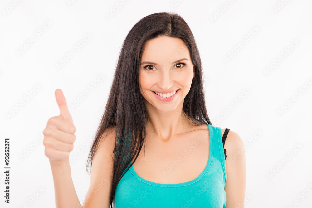 young woman showing thumbs up and smiling young woman showing thumbs up and smiling