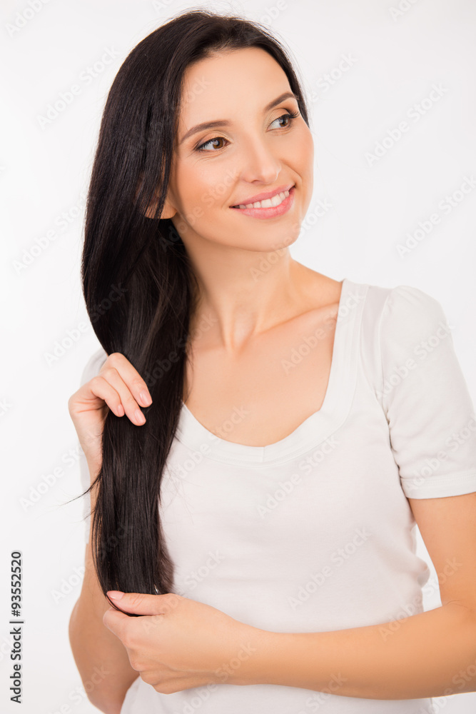 beautiful young woman holding her long hair in hands beautiful young woman holding her long hair in hands