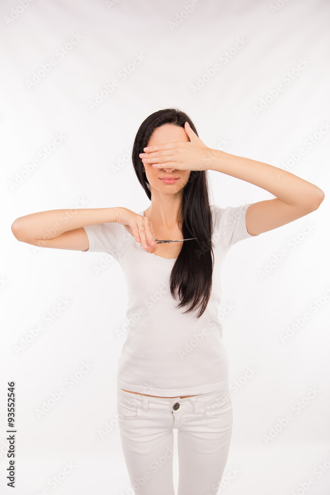 disappointed woman going to cut her split ends of her long hair disappointed woman going to cut her split ends of her long hair