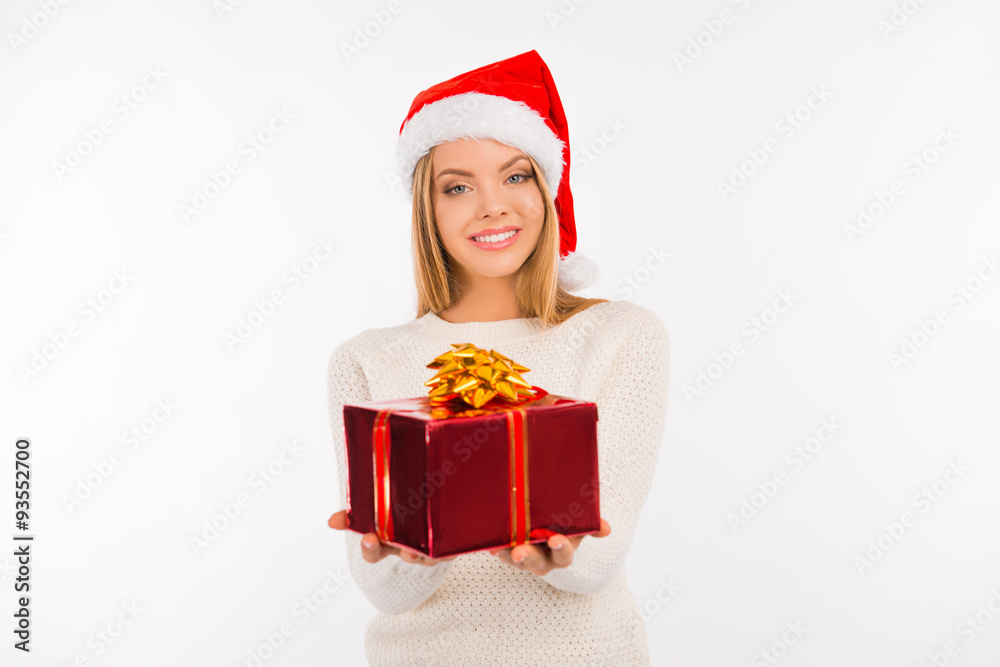 Happy young woman in santa hat with Christmas presents Happy young woman in santa hat with Christmas presents