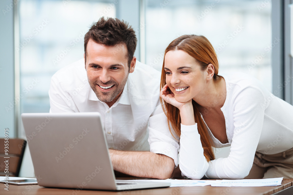 Two business partners working on laptop Two business partners working on laptop