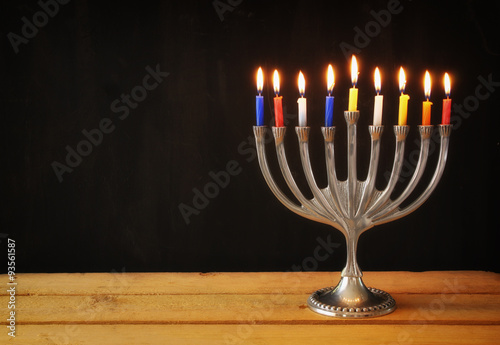 low key image of jewish holiday Hanukkah with menorah (traditional Candelabra)  with chalkboard background, room for text
