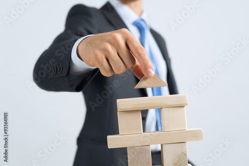 Businessman making tower