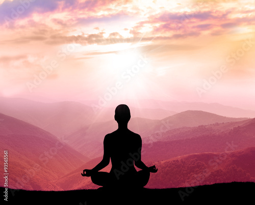  Yoga and meditation. Silhouette of man in the mountain