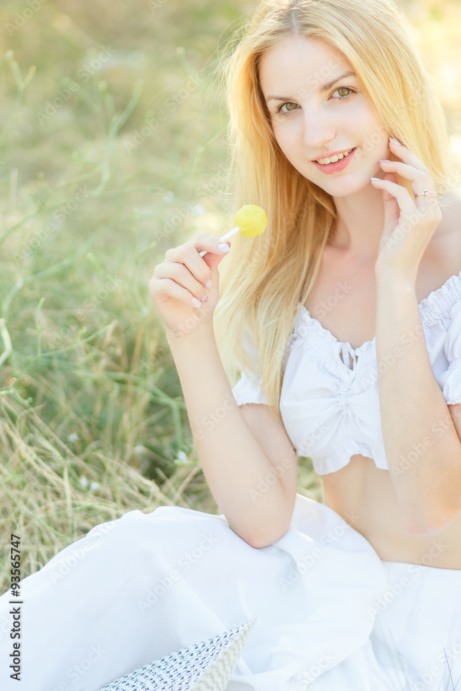 Young sexy woman sucking lollipop. Urban style. Outdoors, lifestyle. Young sexy woman sucking lollipop. Urban style. Outdoors, lifestyle.