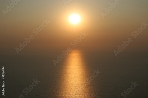 The sun is setting into the sea. On the water visible to the sol