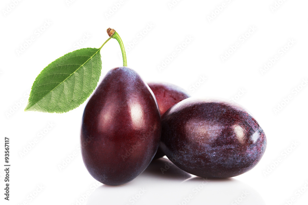 Obraz premium plums with leaves on white background.