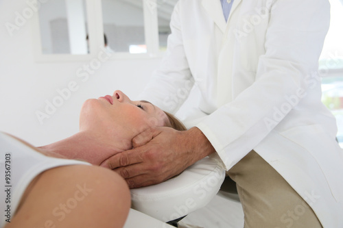 Chiropractor touching woman's head