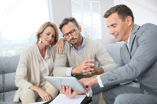 Financial adviser showing terms of contract on tablet
