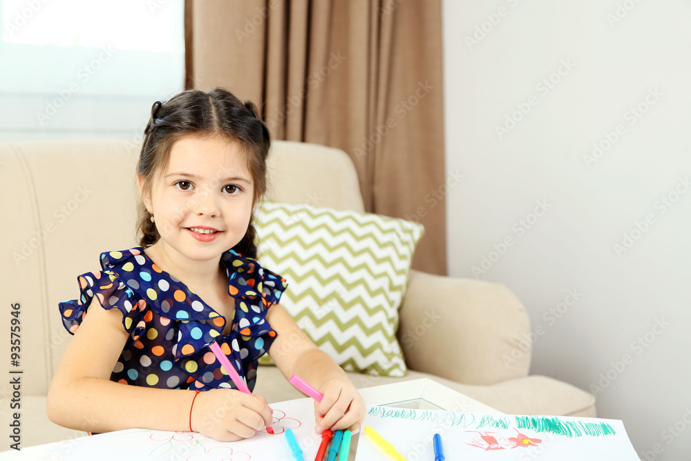 Cute little girl drawing picture on home interior background Cute little girl drawing picture on home interior background