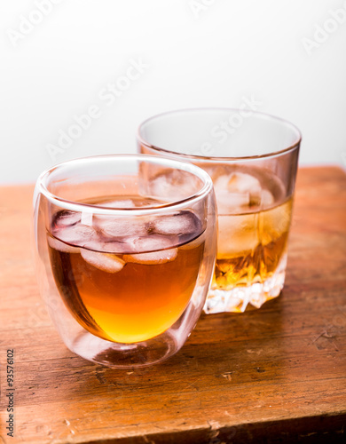 whiskey in glasses on wooden table